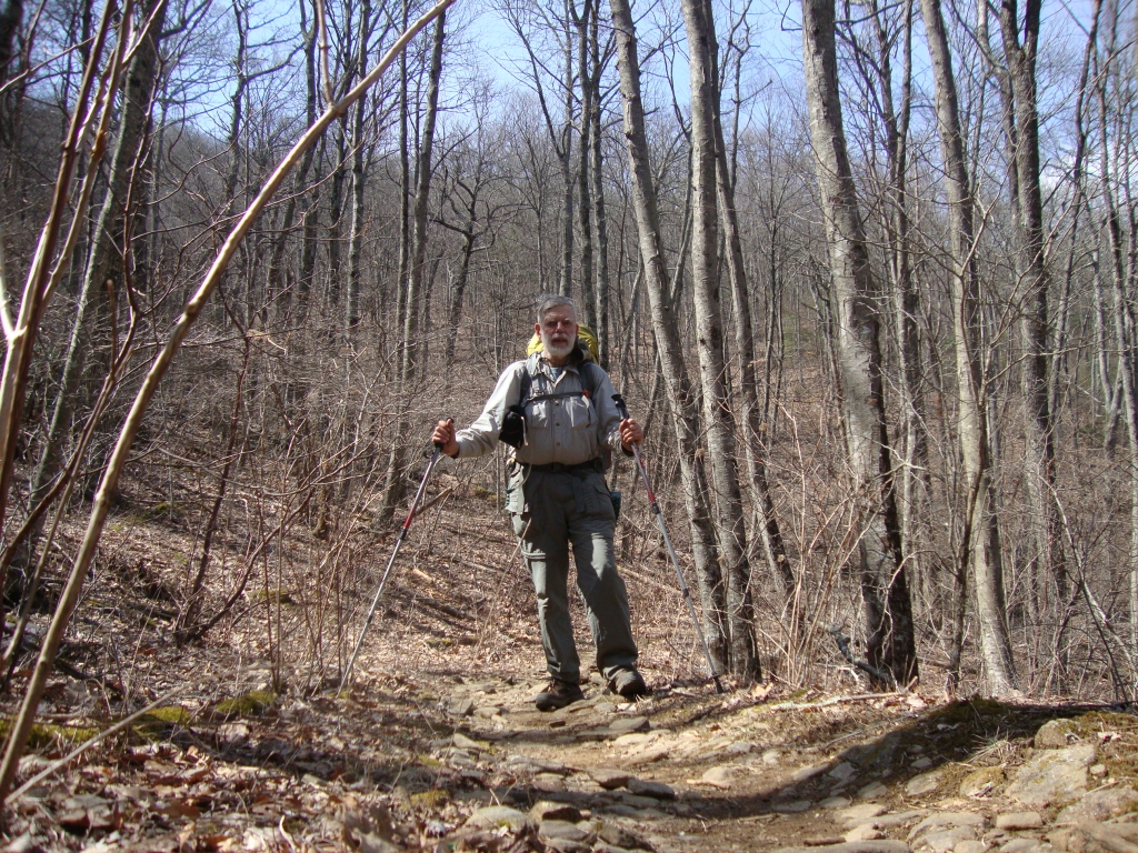One could see a long way through these leafless deciduous woods, with only an occasional evergreen. I should have been in my shorts! My hat is off, resting on the pack with its cord around my neck.