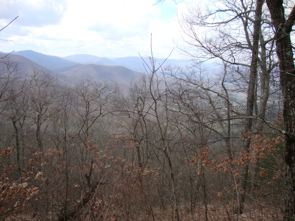 About 12:30 PM I was nearing the top of a hill and snapped this, looking southwest. There's some body of water down there.