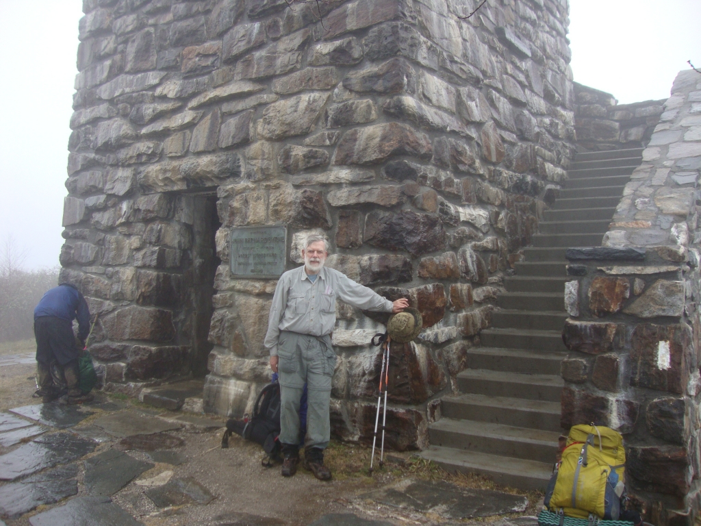 A few minutes later we reached this stone Wayah Bald fire tower, so cold and dank inside that even the protection from the wind wasn't enough to make it attractive. Two Socks and D B Cooper were here; I snapped their photo, and Two Socks took this of me.