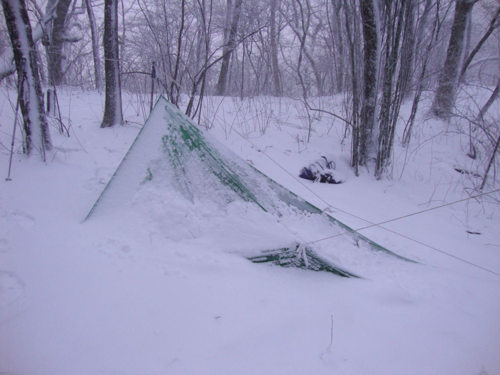 This is my Cold Spring camp the next morning (Monday, March 25)! Besides several inches of snow, freezing rain made it very difficult to untie the knots from my food bag, hanging from a nearby limb, and tarp ropes.