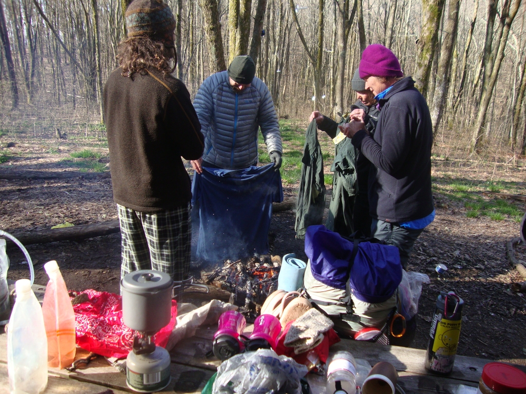 After a miserable day (cold, wet, and ascending) I arrived here at 1:00 PM Friday April 19, immediately donning dry clothes and spending all afternoon in my bag. Here, we're thawing frozen clothes and boots at 9:18 Saturday morning; I had to thaw my frozen boots.