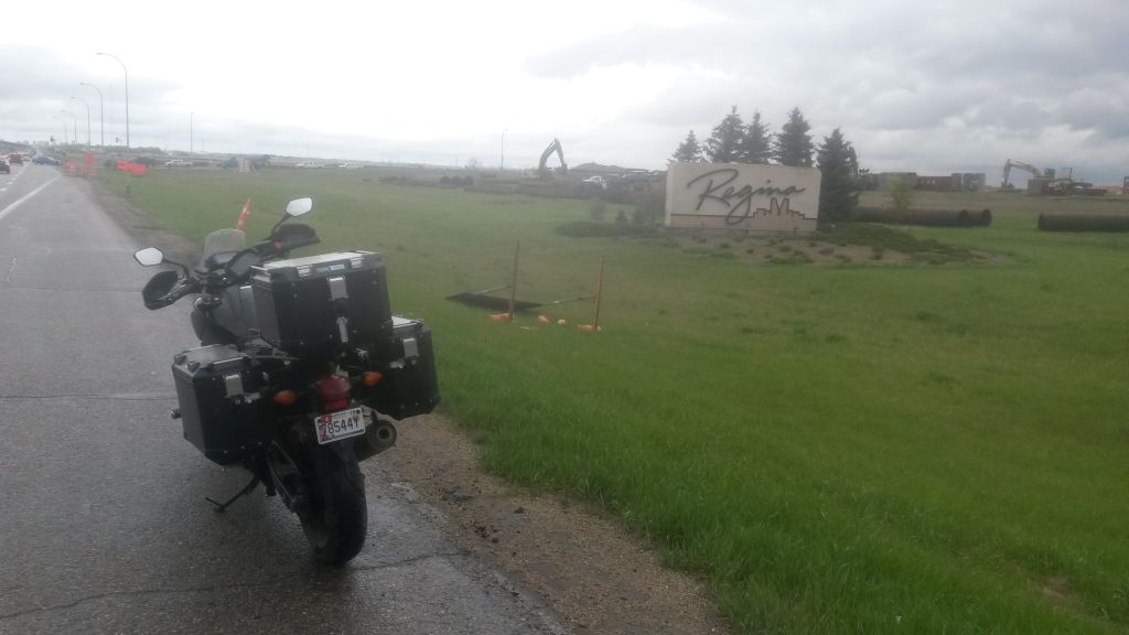 Day 8, to Swift Current SK: Brandon MB to Swift Current SK today, with stiff wind gusts literally a pain in the neck and scattered rain. Around noon I snapped this for a former colleague who grew up in Regina. I sent her a similar photo in 2010.