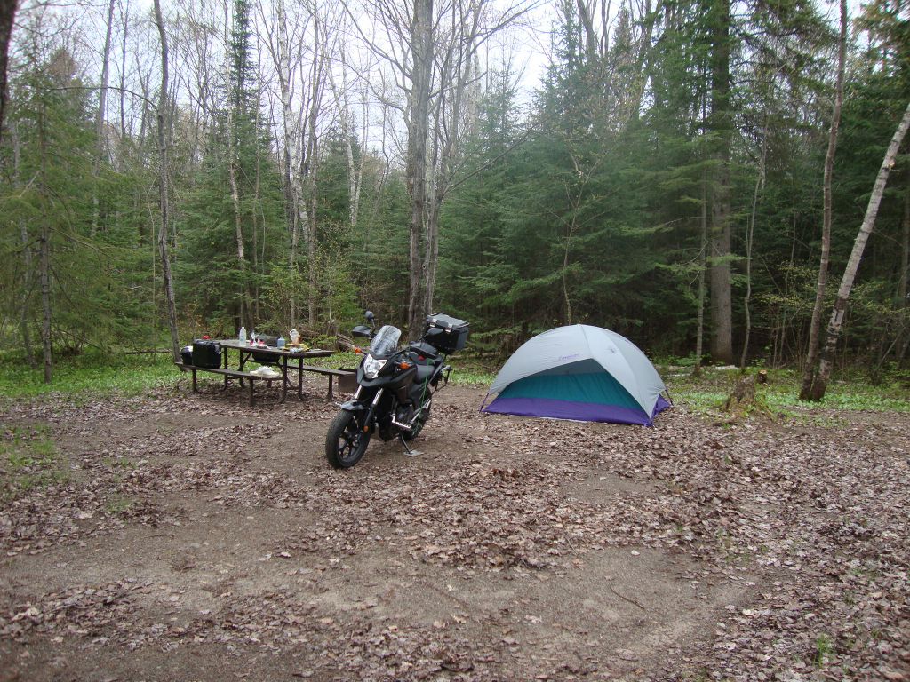 The Pancake Bay camp: The "duckfoot" square of thick aluminum was needed under the sidestand on this soft dirt. I spent a restful night in light rain.