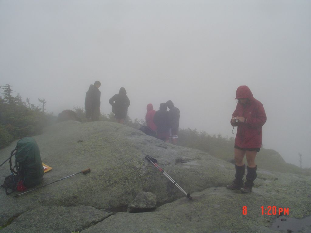 Although my clothes are all soaked, the red ArcTeryx cuts the wind. My photographer came up from Panther Gorge.