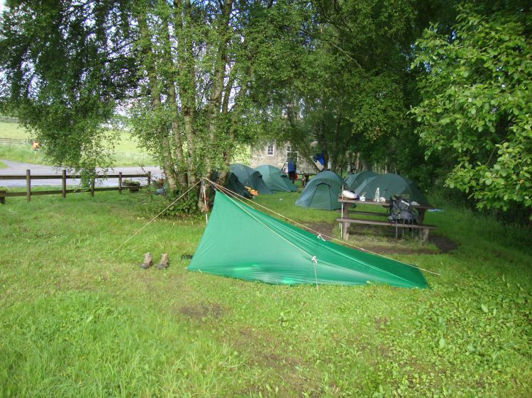 I depacked at  Ballindalloch Station, on the River Spey, at 4:40 PM. The afternoon had included some steep climbing, attractive woods, then a descent to and crossing of A95. I was grateful that the day's final two miles, almost to Mile 31 of the Way, were on a level road along the river. A group of about a dozen nice teenagers, doing the Duke of Edinburgh Canoe Challenge, was already there.