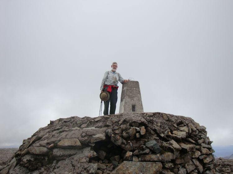 Ben Nevis! At my photographer's insistence I clambered up to the summit obelisk at 1:00 PM. The path had crossed about fifty feet of  snow fifteen minutes earlier. It was a beautiful day, and there were probably 30 people on the summit.