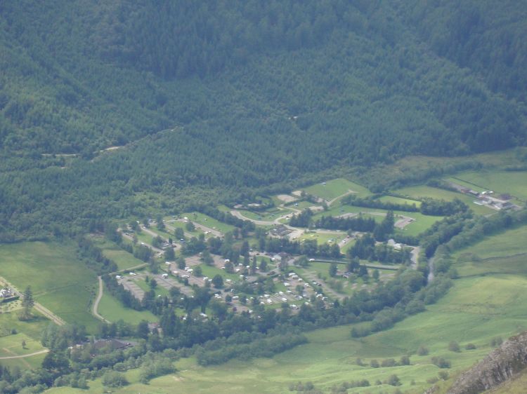 I left the summit at 2:00 PM, and an hour later tried this 8x zoom shot of the campground. My tarp, staked flat because I was hiking with its support pole, is at the left end of the rectangular field just below and right of center, across a wide gravel area from the large bathroom building. 